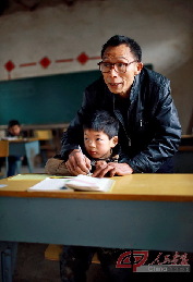 教学前班的孩子生字时，李祖清都会先握着孩子的手写一遍，再让他自己写几遍。