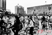 1992年，深圳市中心深南大道上，邓小平巨幅画像前行人如织。那一年，邓小平的南方讲话，坚定地回答了改革开放“姓资姓社”的讨论，也开启了新中国历史上经济发展最快的时期。 摄影 安哥